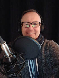 Colour picture of Author Alan C Bruce recording his book.